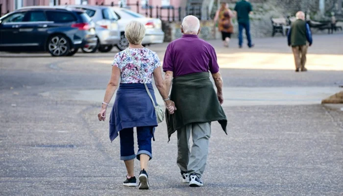 retired couple holding hands